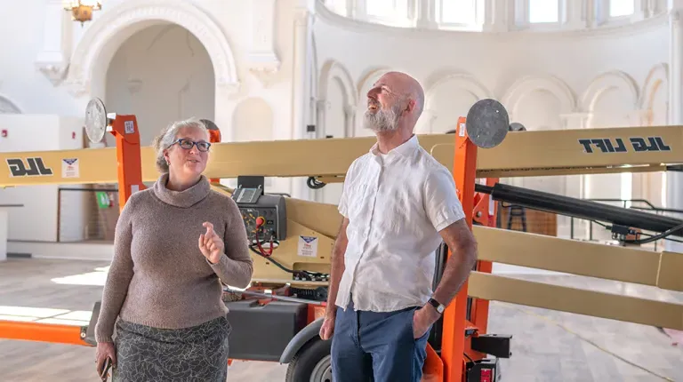 Brad Favreau and Alethea Cariddi staning infront of renovation equipment in the Biddeford community center