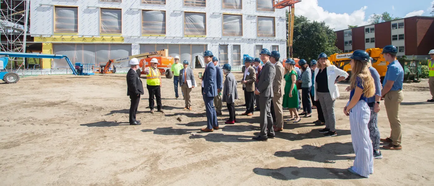 A crowd gathers outside the construction of the new health sciences building on U N E's Biddeford campus